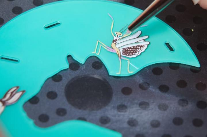 工艺师在面盘手绘上螳螂图案。