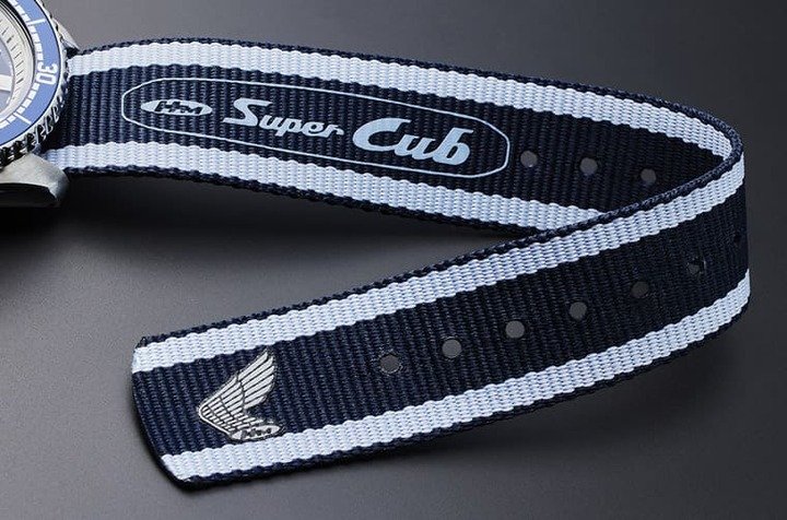 深蓝／浅蓝双色尼龙表带饰有”Super Cub”字样及HONDA Logo。