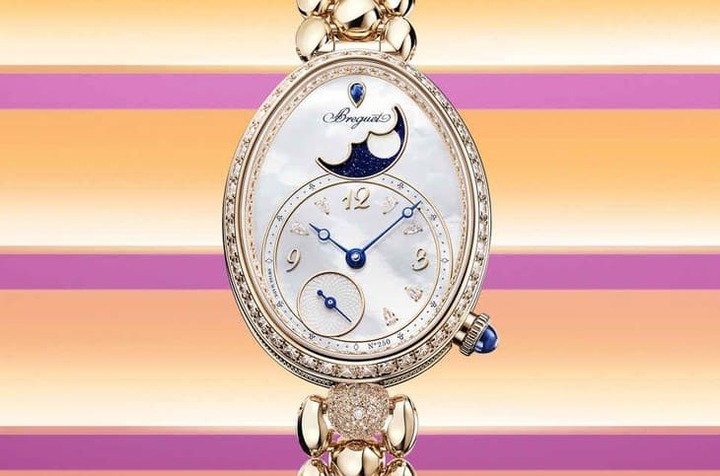 Reine de Naples 9935 面盘以砂金石玻璃衬托珍珠母贝，放大月相显示并融入六颗梨形钻石时标，光影流转梦幻。